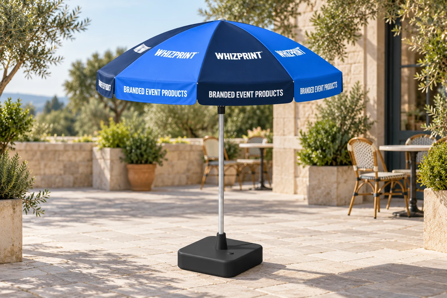 Navy and blue Whizprint parasol with repeated canopy logos and valance lettering on a terrace, supported by a weighted base.