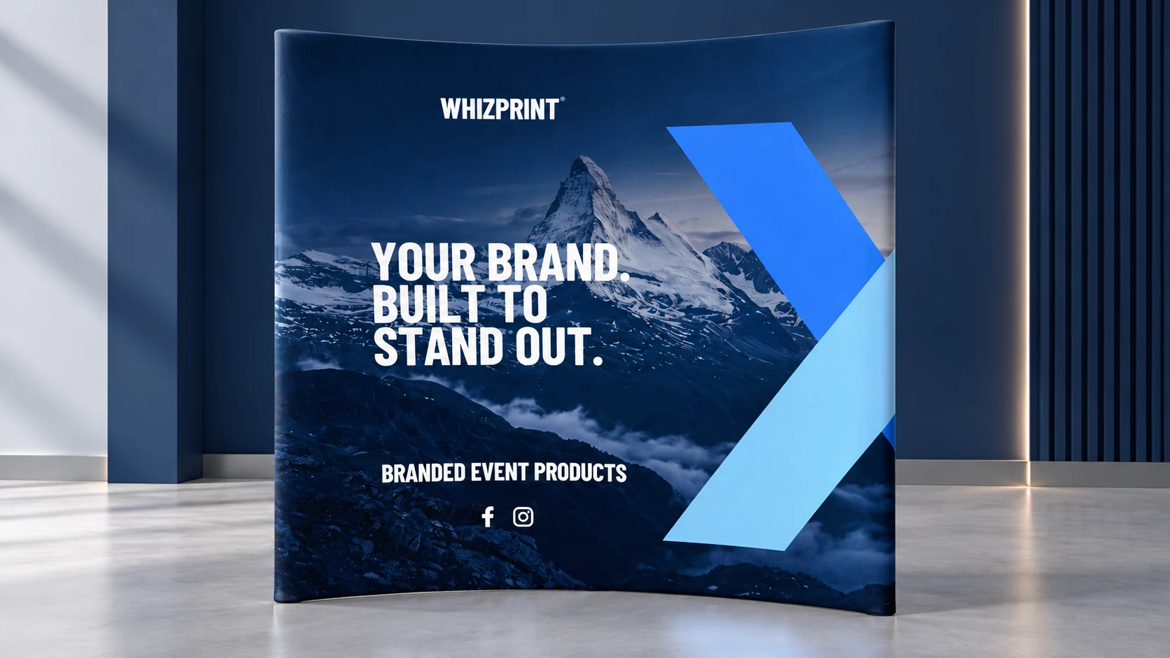 Curved Whizprint fabric pop-up display with navy and blue artwork in an indoor studio illustration.