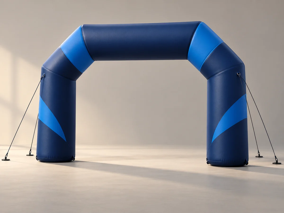 Conceptual navy and blue inflatable event arch with tether lines on a neutral studio background