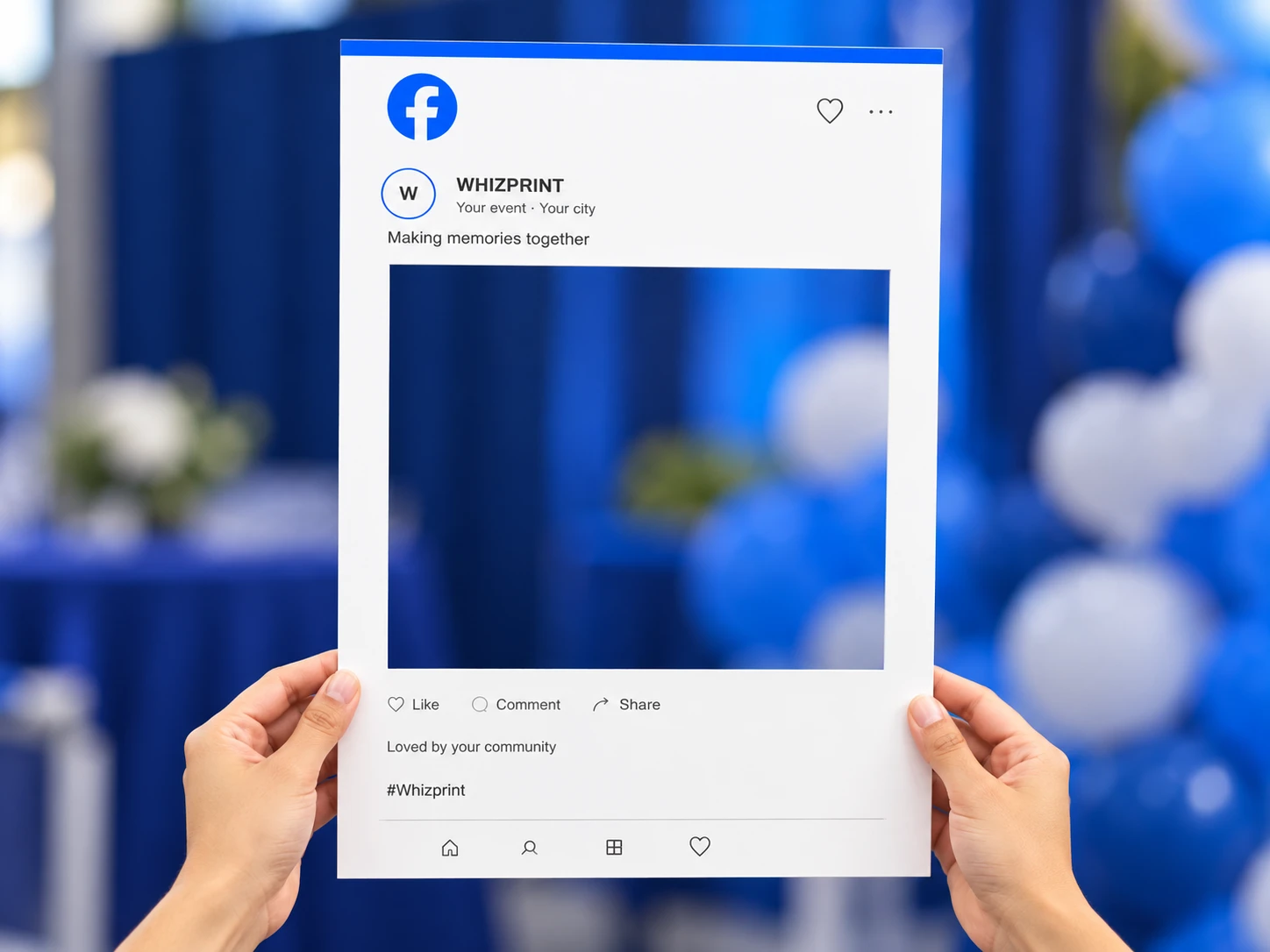 White Whizprint social media photo frame held at its lower edges, with a blue event backdrop visible through the rectangular opening.
